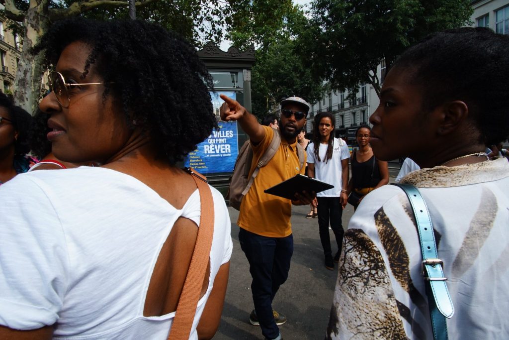 A tour guide pointing to a tourist attraction